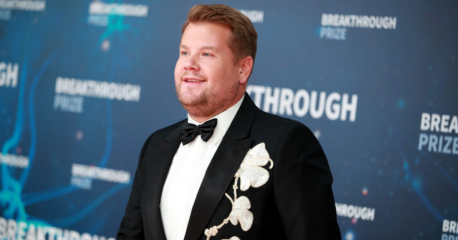 James Corden at an event in a black suit with flower embroidery
