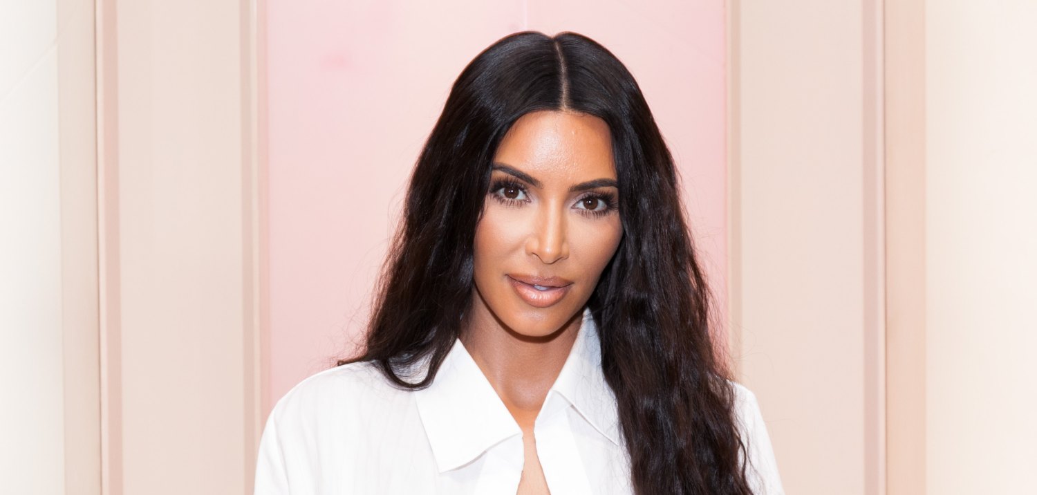 Kim Kardashian on a light peach background.