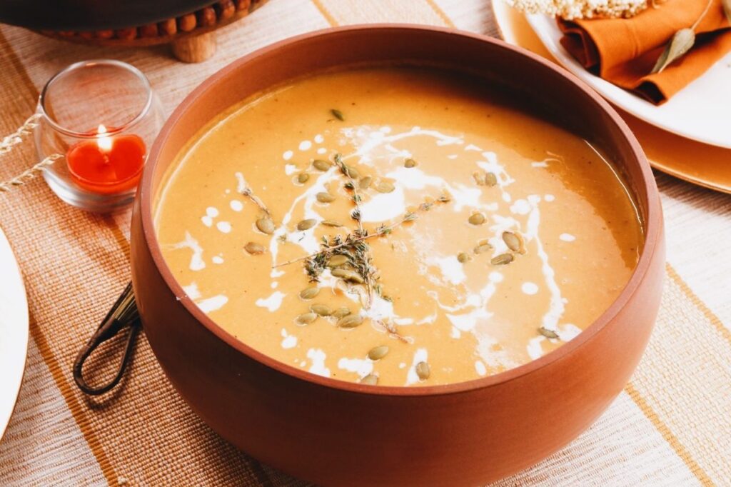 Photo shows a "velvety" butternut squash soup, upgrading a commonplace vegan side into a main dish.
