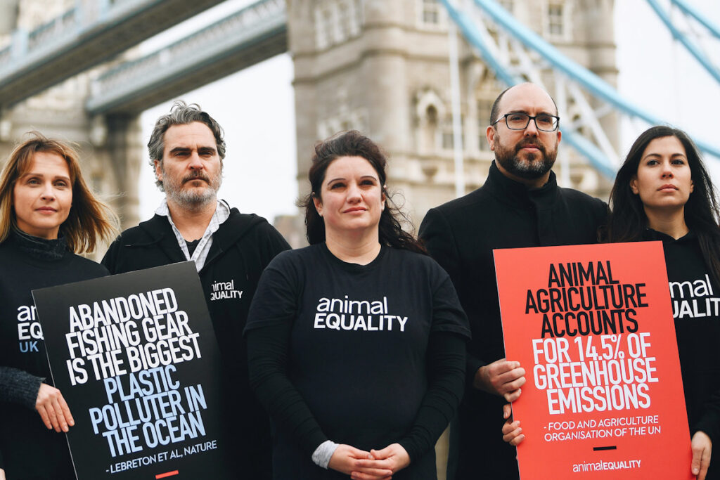 Photo shows Joaquin Phoenix and two other protestors on London Bridge.