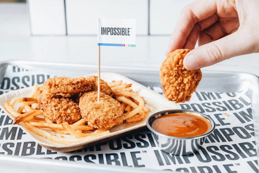 Impossible Foods chicken nuggets being dipped