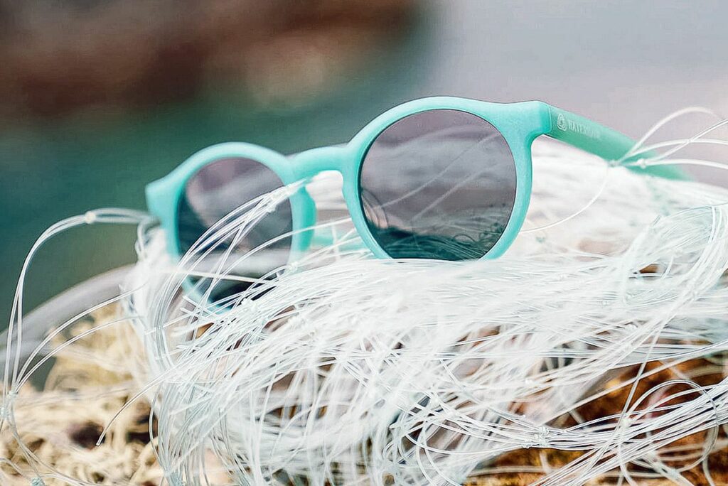 green sunglasses on a pile of fishing net