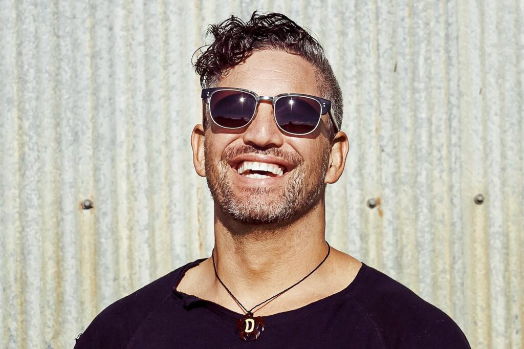 a smiling man wears Pala sunglasses