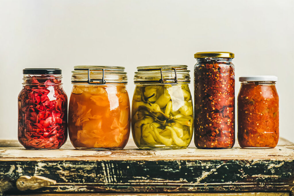 Photo features a row of jars filled with fermented vegetables and other ingredients. What is fermentation?