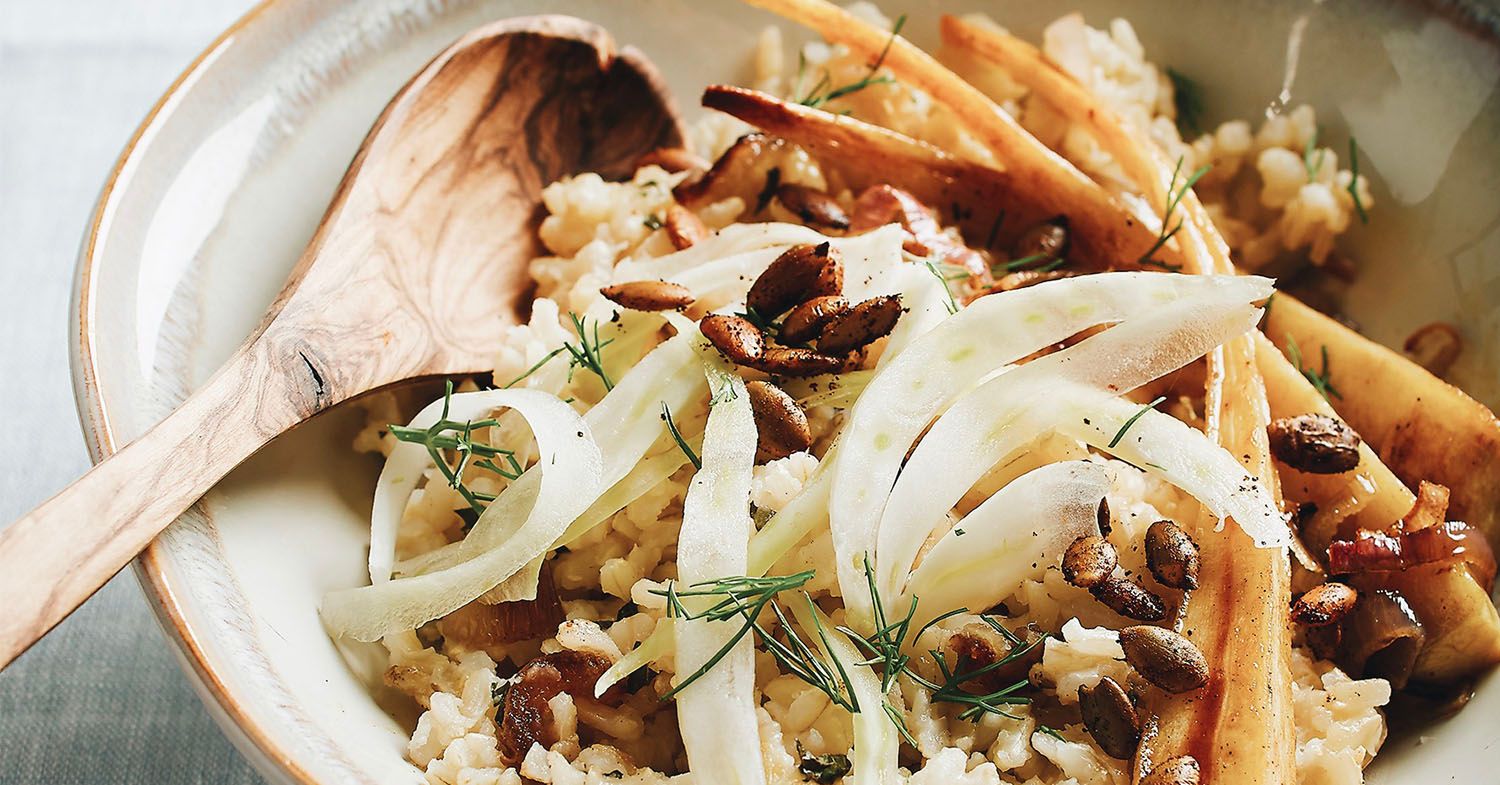 Photo of a brown rice bowl with maple-roasted parsnips, shallots, and spicy pumpkin seeds