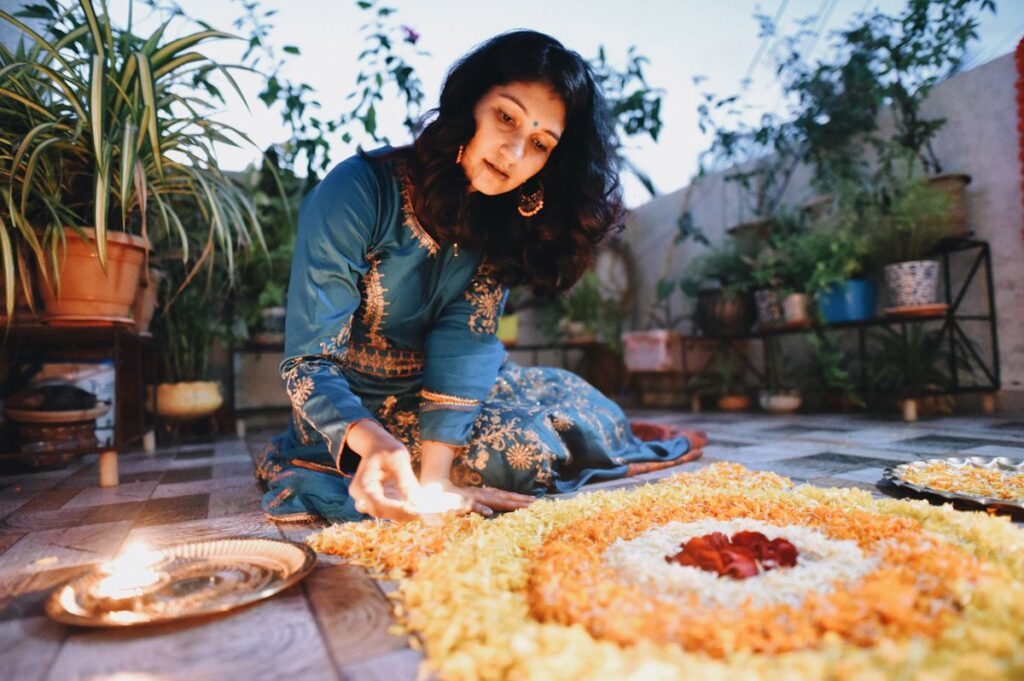 A Hindu woman lights a candle during the divali