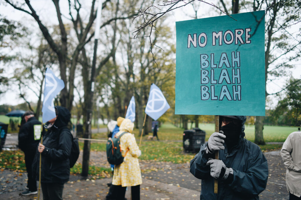 Photo shows Extinction Rebellion protesters taking part in a 'Stop Climate Horror' fancy dress march on October 31. One carries a sign painted with a quote from Greta Thunberg: "No more blah blah blah."