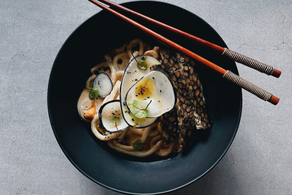 Photo shows the spicy udon dish from Matthew Kenney’s Adesse.