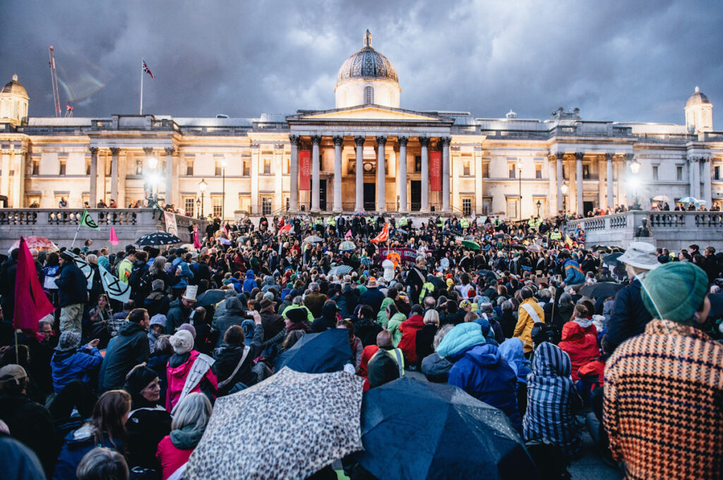 Photo shows Extinction Rebellion protestors gathering in Trafalgar Square, London, for speeches.