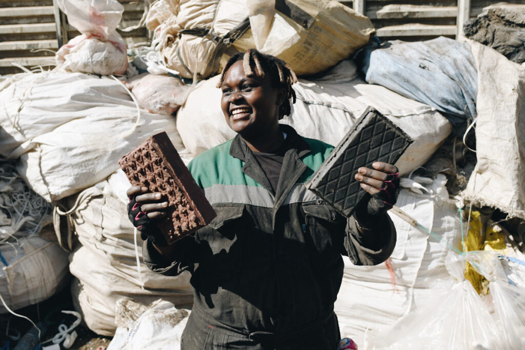 Photo shows Kenyan entrepeneur Nzambi Matee, who is fighting plastic waste by turning it into bricks.