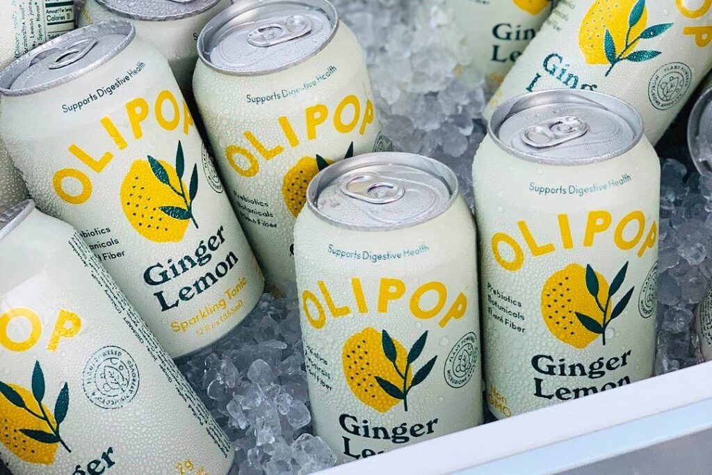 Photo shows cans of OLIPOP Lemon Ginger sparkling probiotic drink