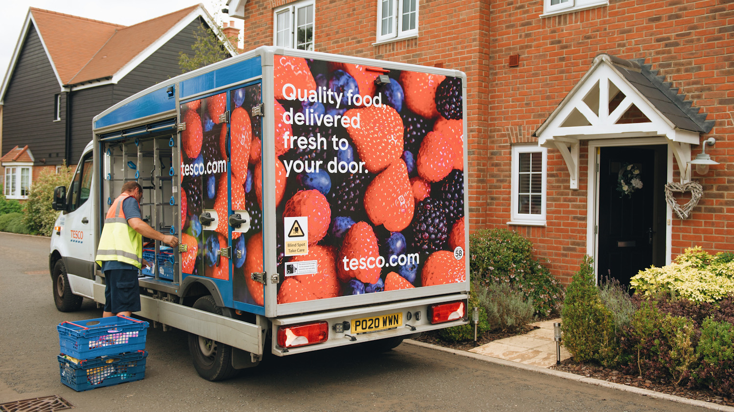 Photo shows a Tesco home delivery truck dropping off food in Chelmsford, England. Tesco is the UK's biggest supermarket and its delivery truck fleet is going electric.