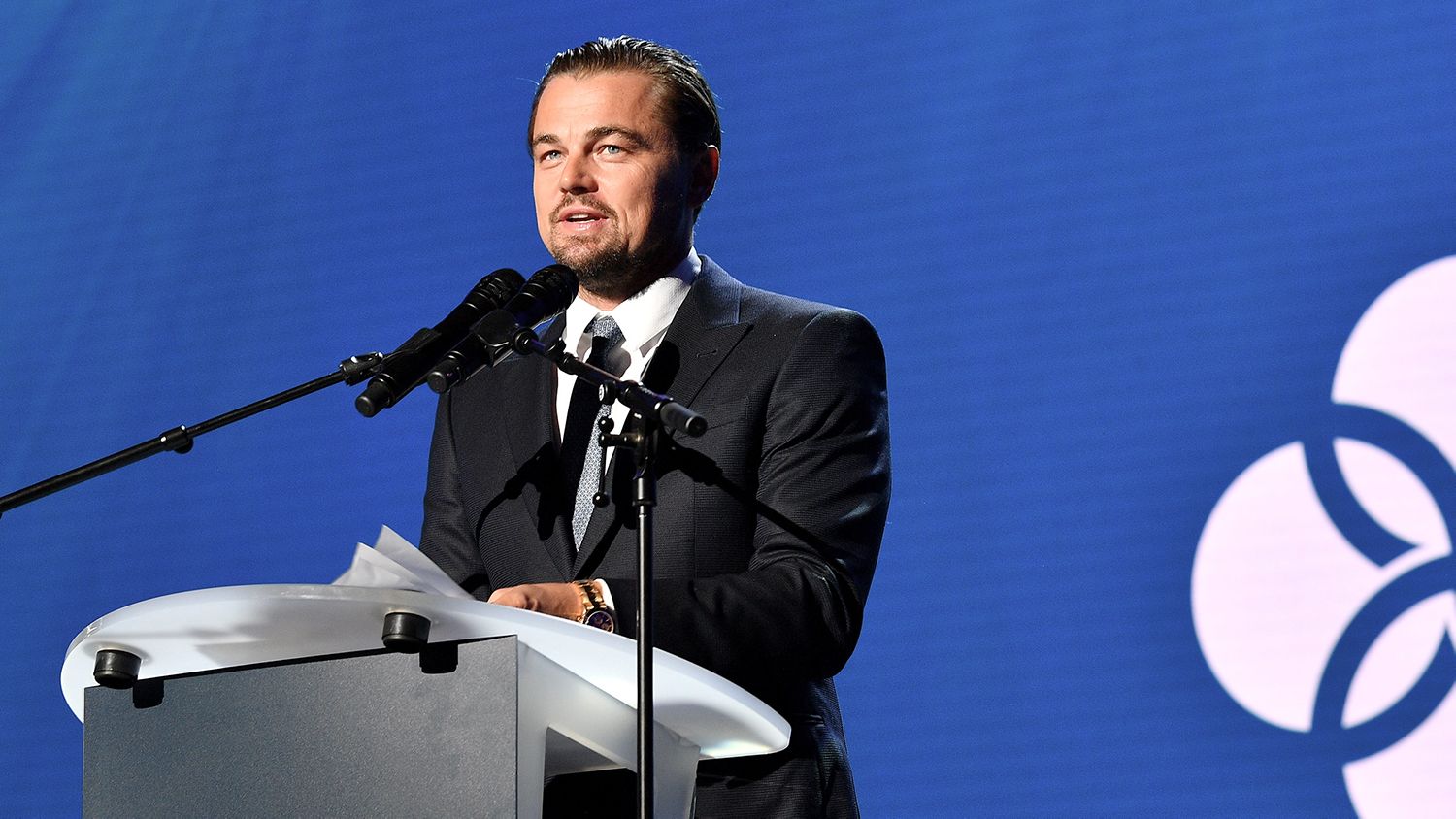 Image shows Leonardo DiCaprio delivering a speech during a climate conference in Paris