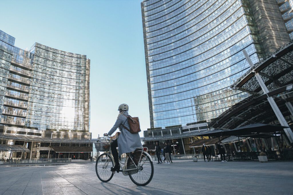 Photo shows a cyclist riding through the Porta Nuova district of Milan.